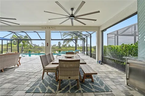 a living room with furniture a rug and a floor to ceiling window