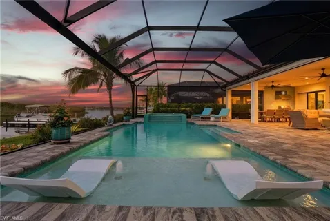 a view of swimming pool with outdoor seating and a yard