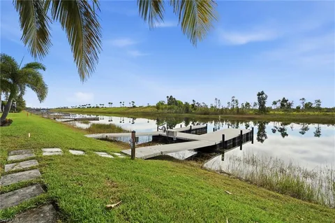 an aerial view of a house with outdoor space and a lake view
