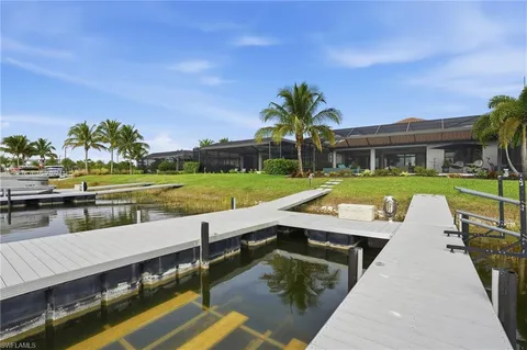 an aerial view of house with yard and swimming pool