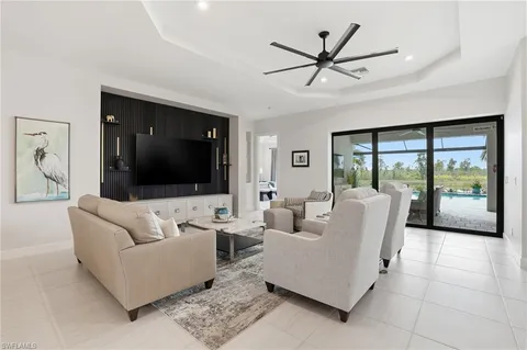 a kitchen with a dining table chairs sink and wooden floor