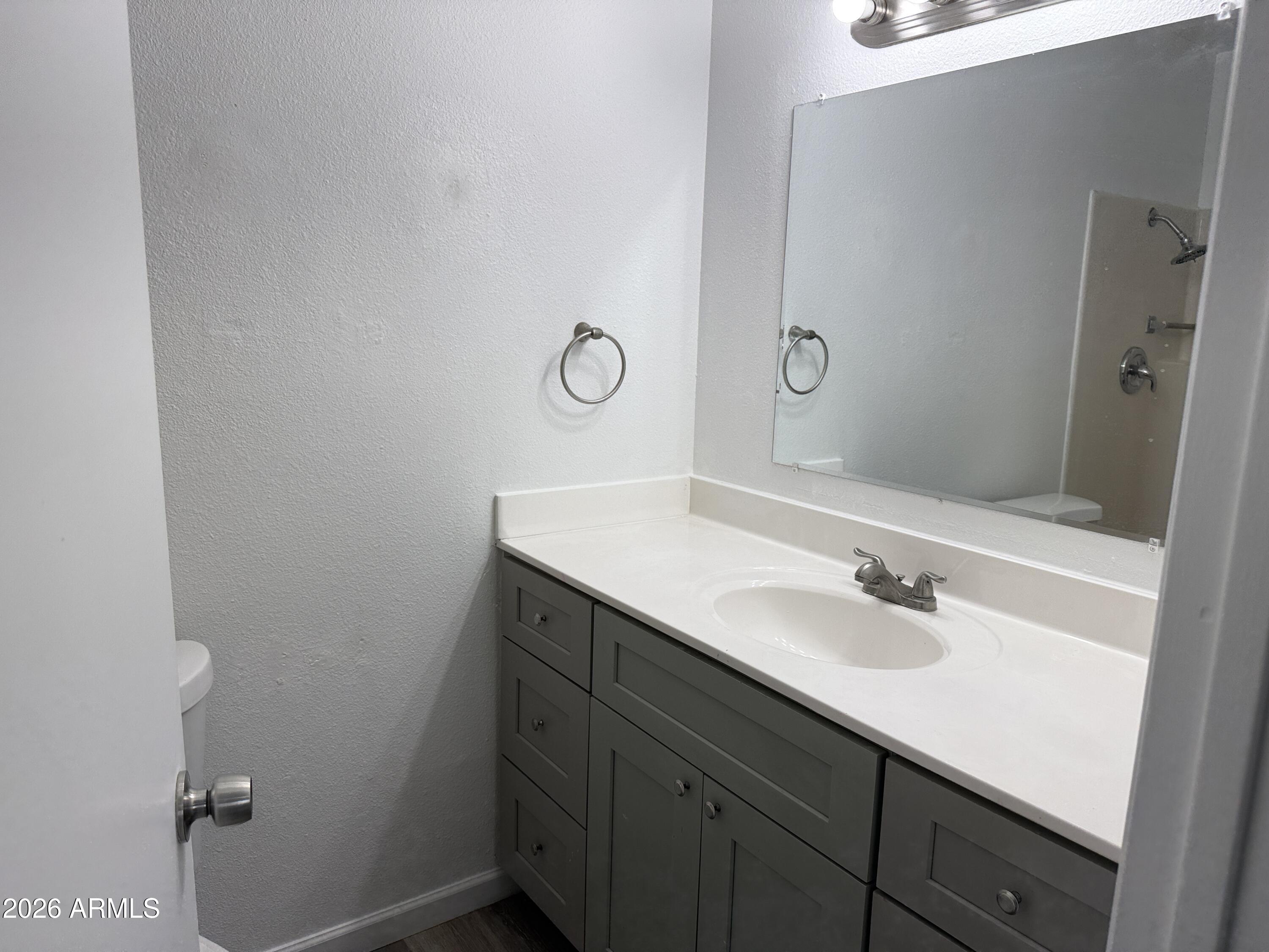 860 East Brown Road, Unit 53 Mesa, AZ 85203 - Photo 12 of 14 a bathroom with a sink and a mirror