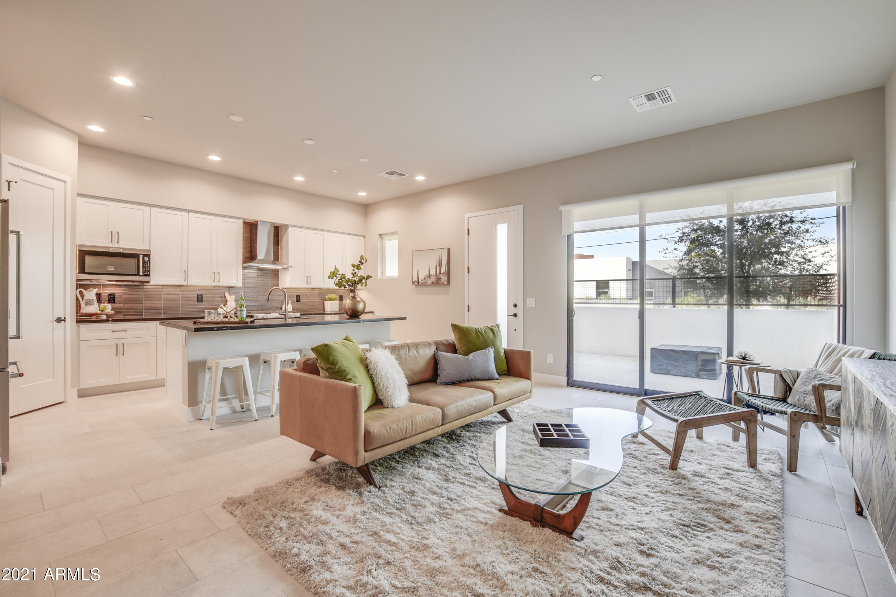 a living room with kitchen couches and a dining table with kitchen view