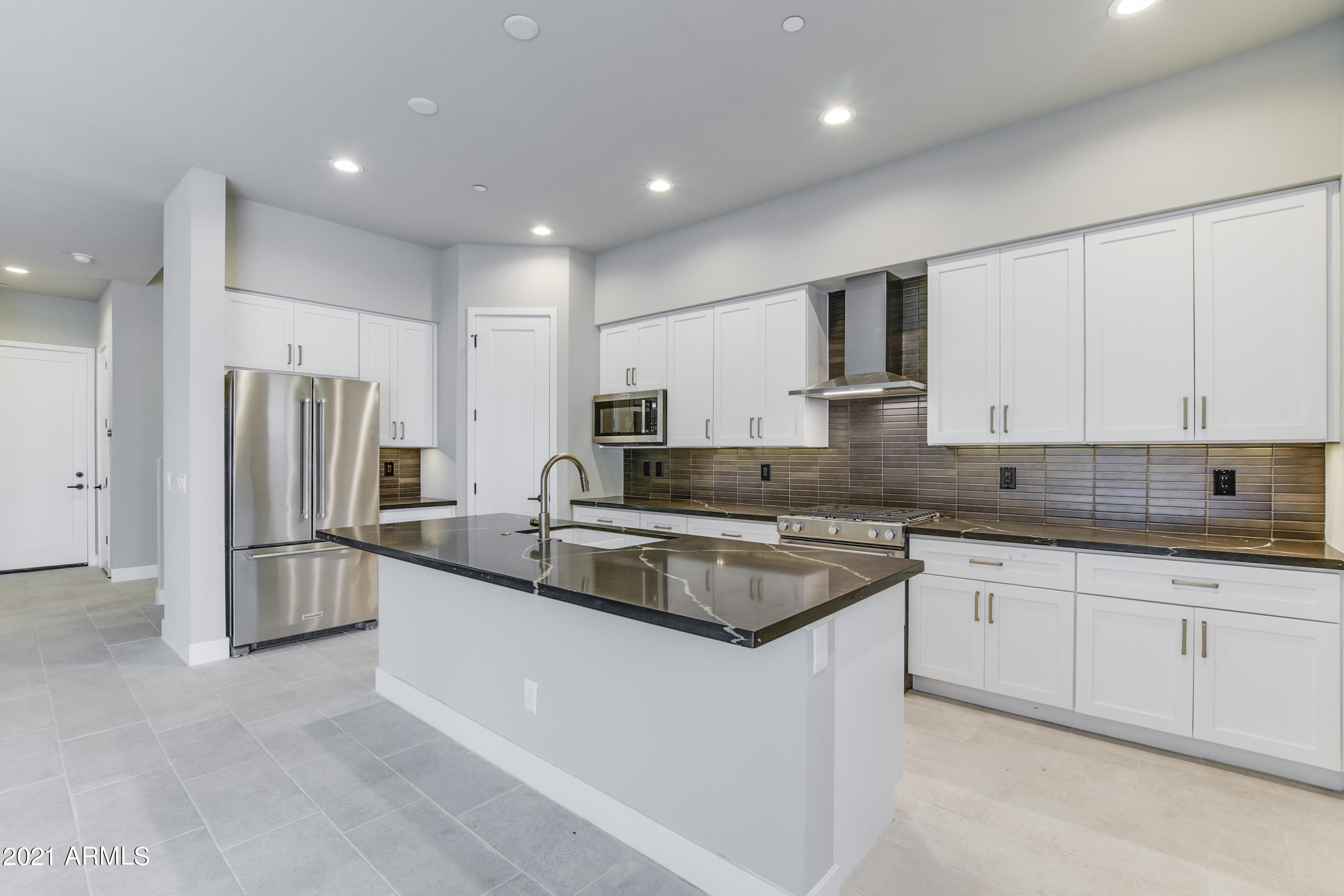 1111 East Missouri Avenue, Unit 3 Phoenix, AZ 85014 - Photo 11 of 24 a kitchen with white cabinets and stainless steel appliances