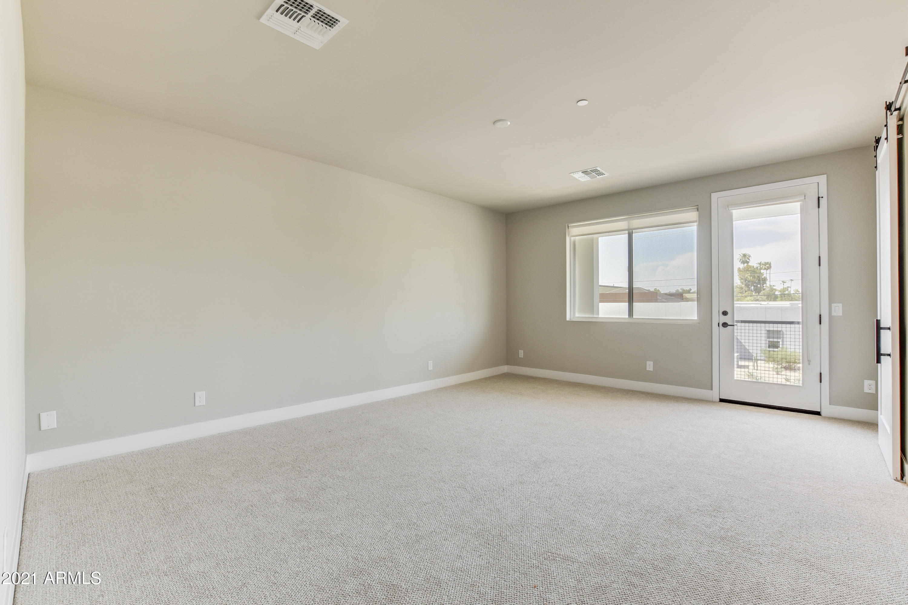 1111 East Missouri Avenue, Unit 3 Phoenix, AZ 85014 - Photo 12 of 24 an empty room with windows