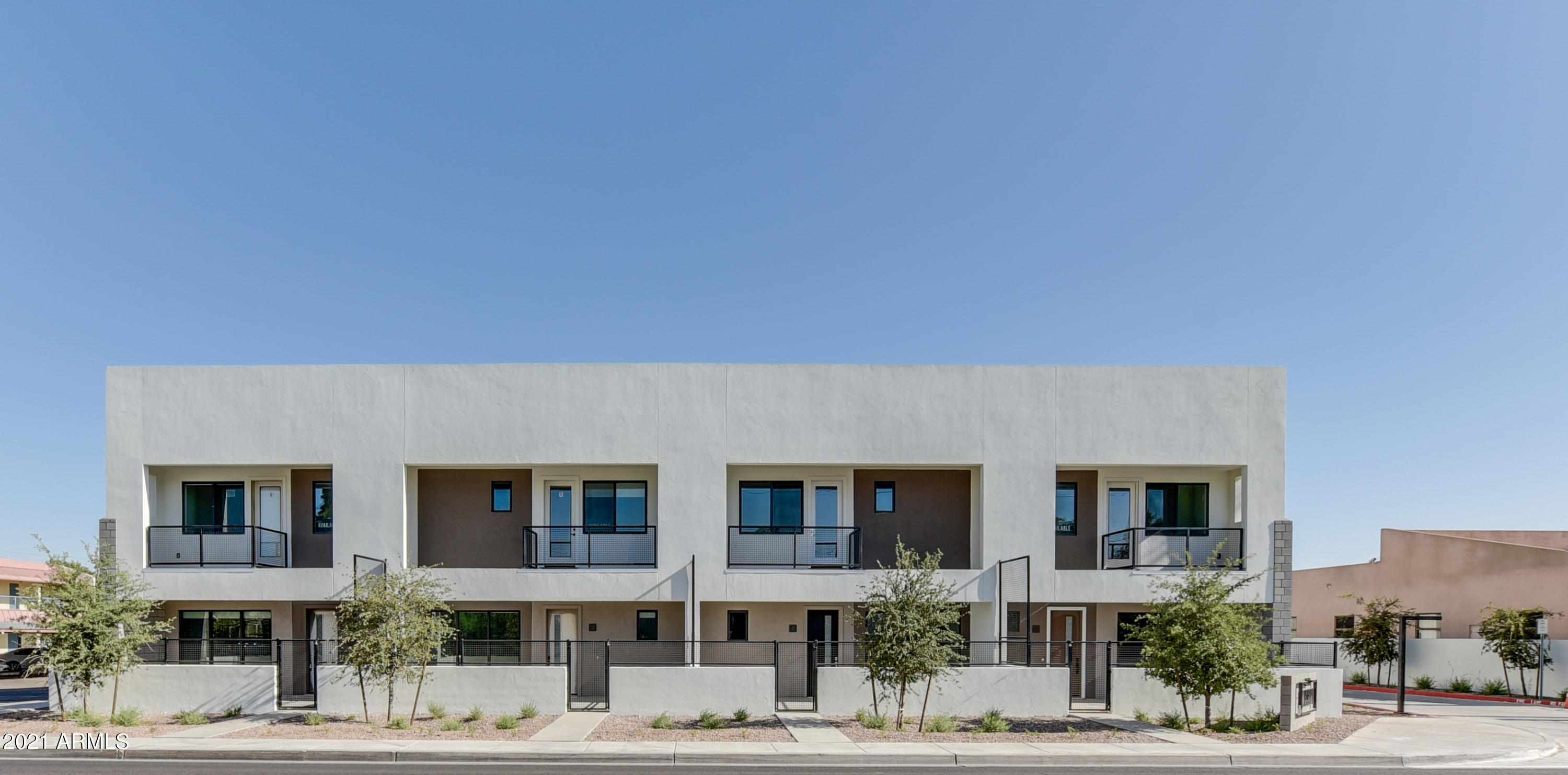 1111 East Missouri Avenue, Unit 3 Phoenix, AZ 85014 - Photo 2 of 24 a front view of residential houses with street