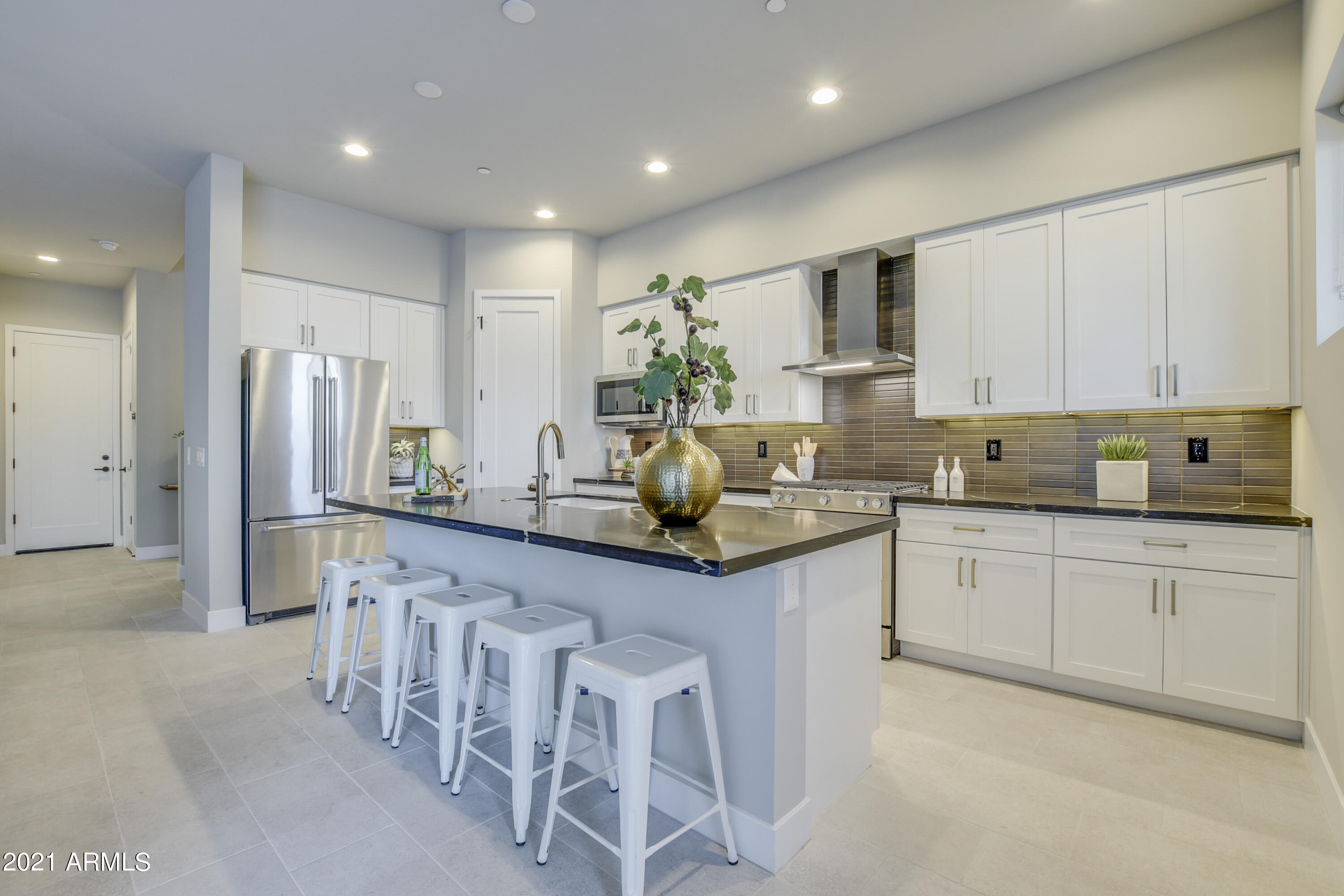 1111 East Missouri Avenue, Unit 3 Phoenix, AZ 85014 - Photo 3 of 24 a kitchen with white cabinets and stainless steel appliances