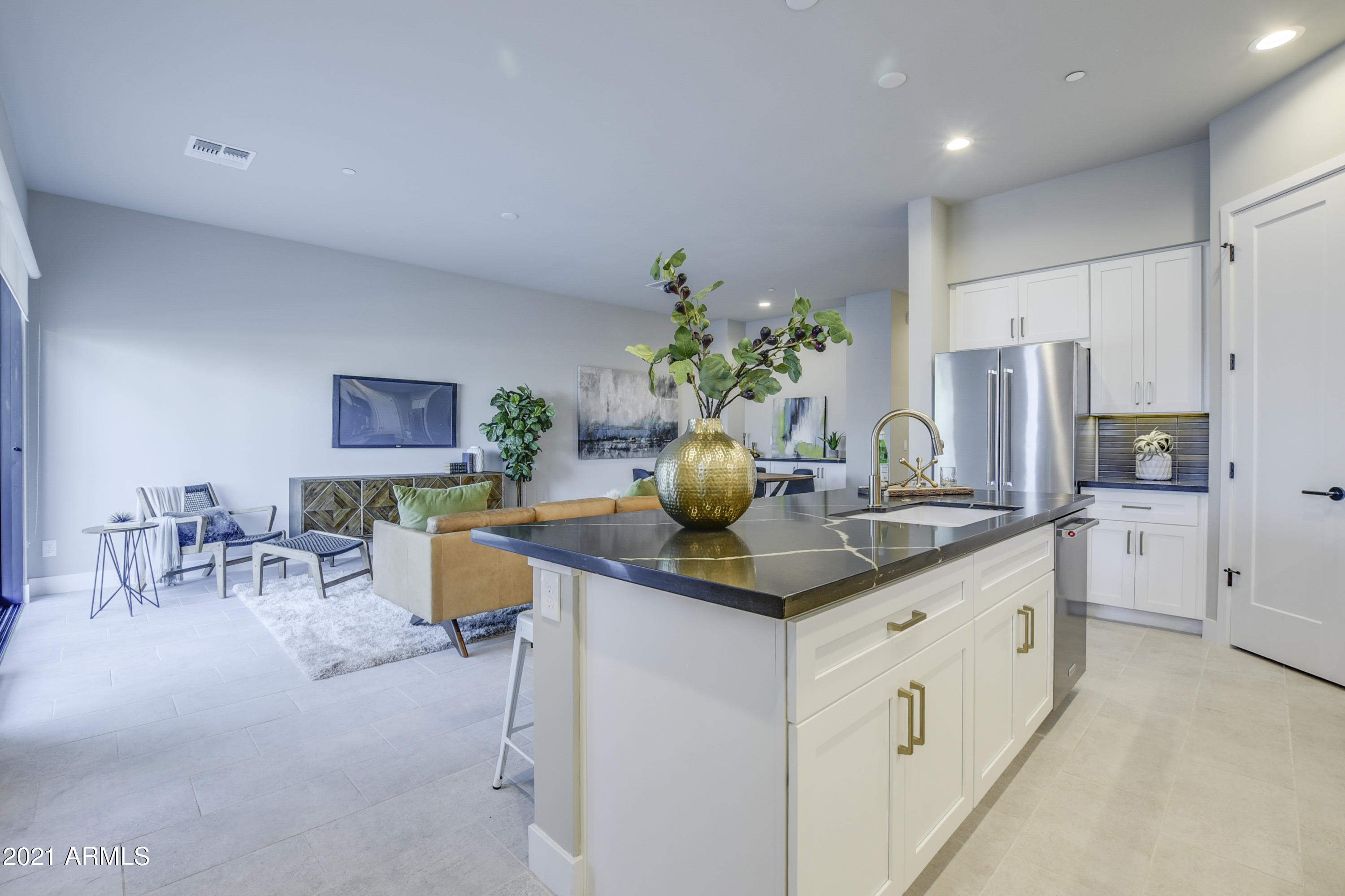 1111 East Missouri Avenue, Unit 3 Phoenix, AZ 85014 - Photo 6 of 24 a kitchen with stainless steel appliances kitchen island granite countertop a table and chairs in it