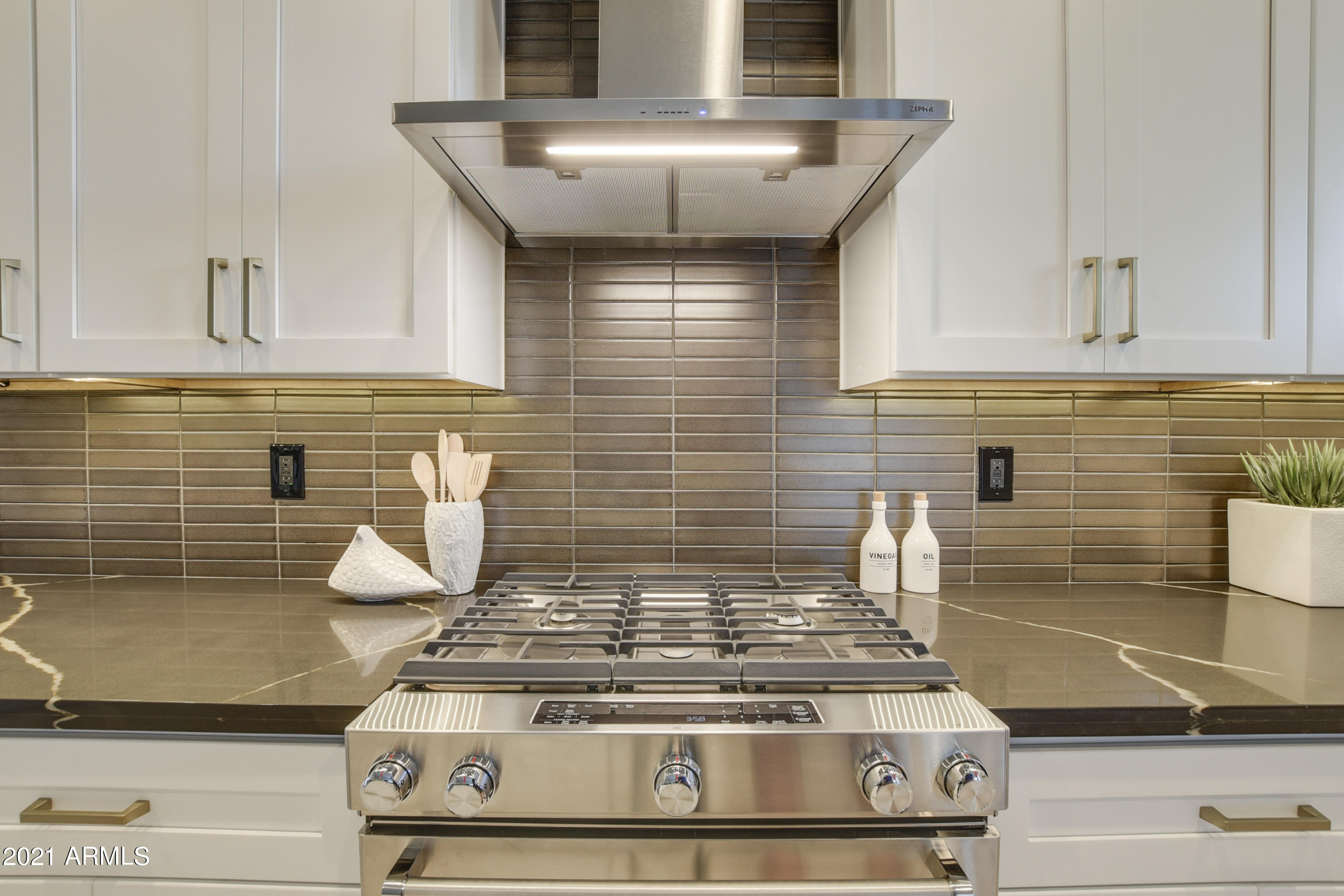 1111 East Missouri Avenue, Unit 3 Phoenix, AZ 85014 - Photo 7 of 24 a stove top oven sitting inside of a kitchen