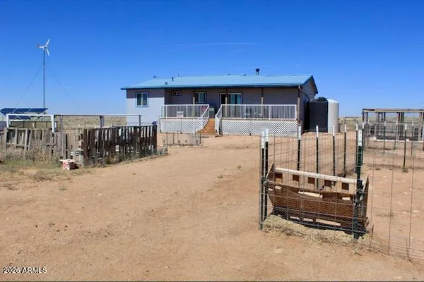 a backyard of a house with barbeque oven and view
