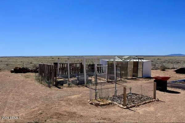 a view of a patio with a table and chairs