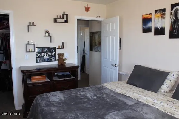 a bedroom with a bed and cabinets