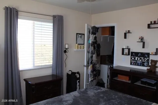 a bedroom with a bed and a window