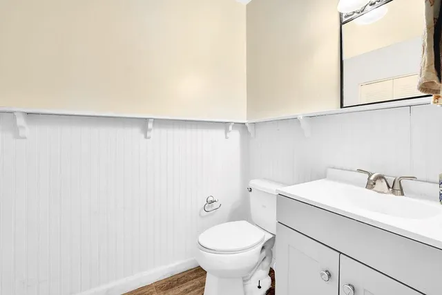 a bathroom with a sink a toilet and mirror