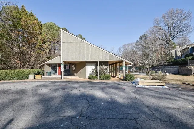 a big house with palm trees in the background