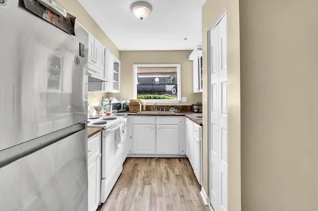 a kitchen with sink cabinets and window