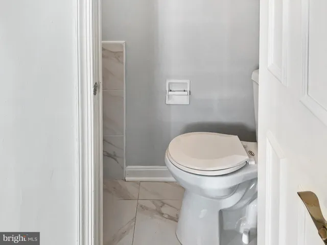 a bathroom with a toilet and a tub
