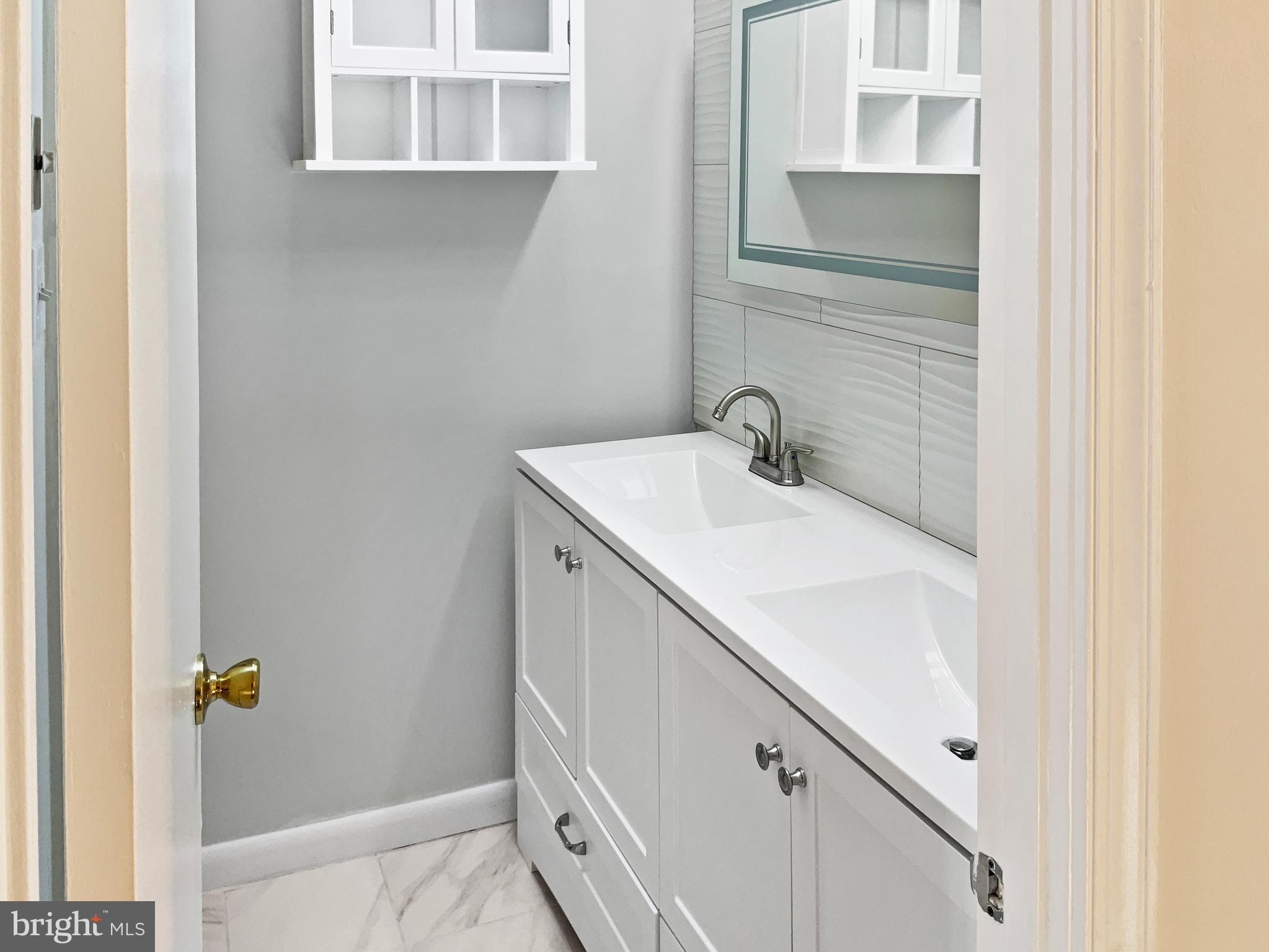 11184 Silentwood Lane Reston, VA 20191 - Photo 15 of 26 a bathroom with a sink and mirror