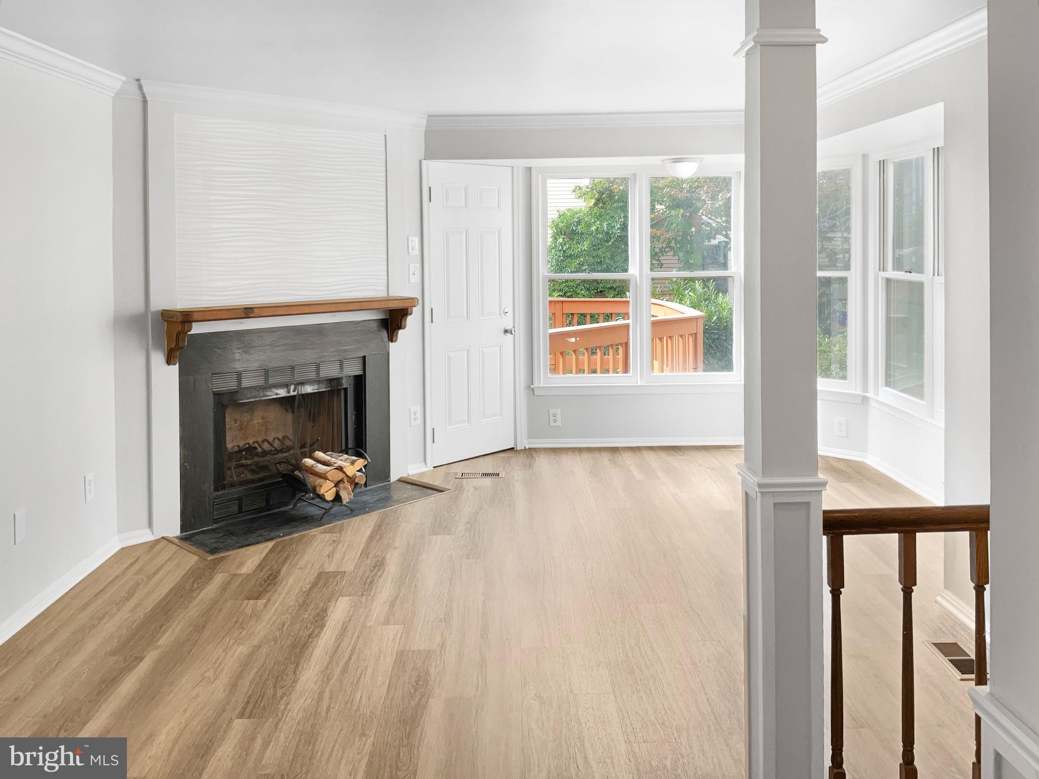 11184 Silentwood Lane Reston, VA 20191 - Photo 3 of 26 a view of an empty room with a fireplace and a window