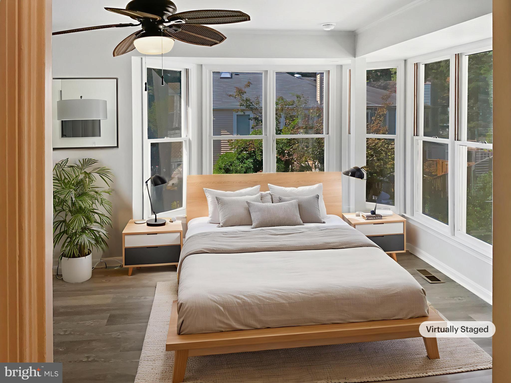 11184 Silentwood Lane Reston, VA 20191 - Photo 4 of 26 a bedroom with a large bed and a potted plant