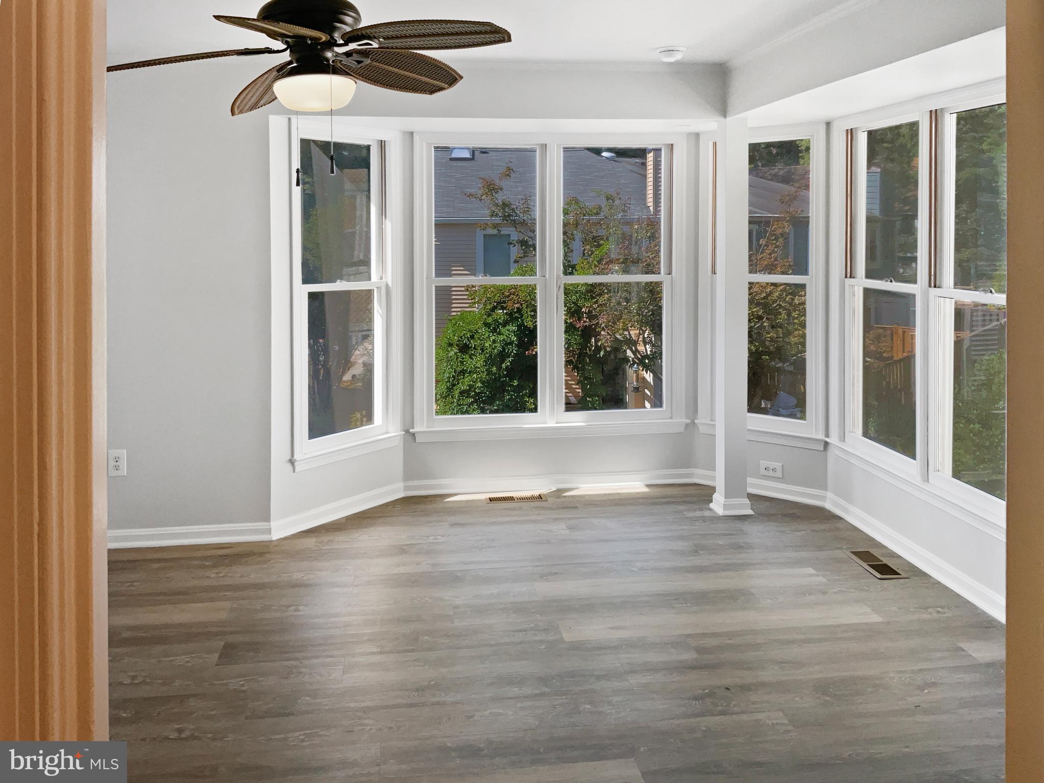 11184 Silentwood Lane Reston, VA 20191 - Photo 5 of 26 a view of an empty room with a window and wooden floor