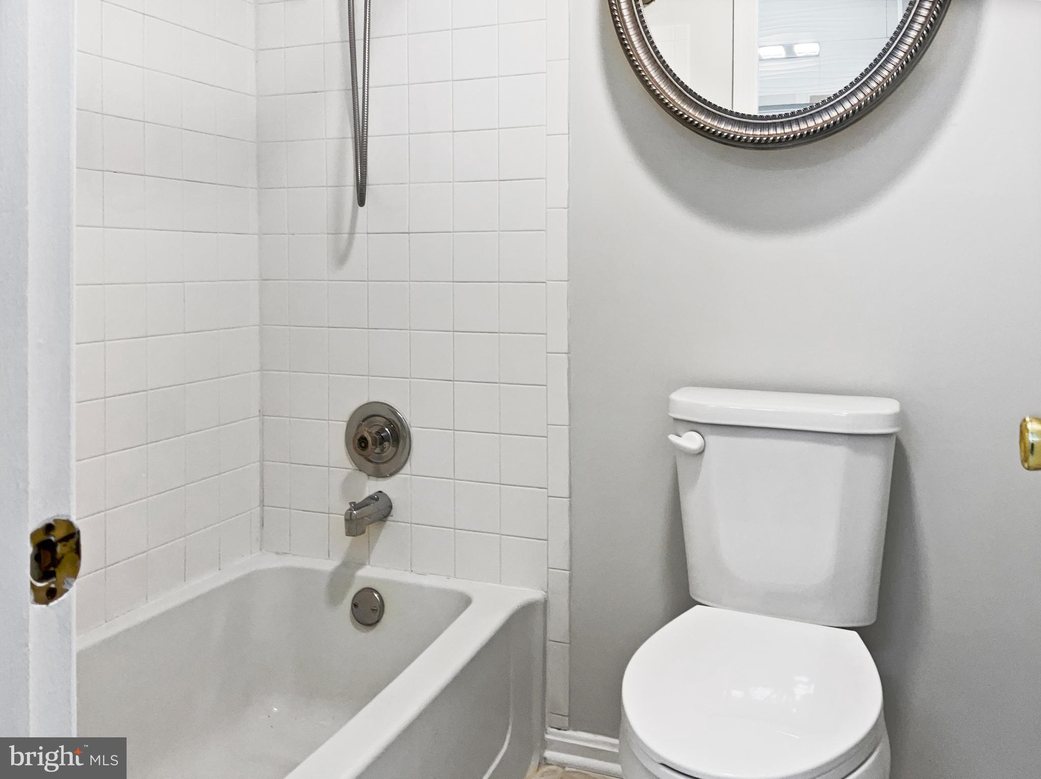 11184 Silentwood Lane Reston, VA 20191 - Photo 7 of 26 a white toilet sitting next to a bath tub
