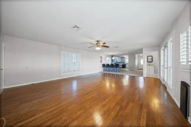 a view of a livingroom with furniture and a ceiling fan
