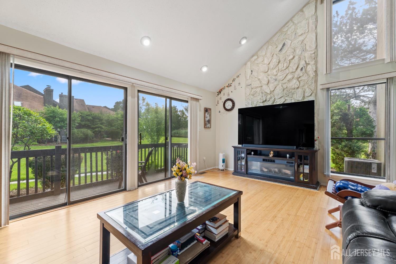 348 Westgate Drive Edison, NJ 08820 - Photo 16 of 43 a living room with furniture a flat screen tv and a large window
