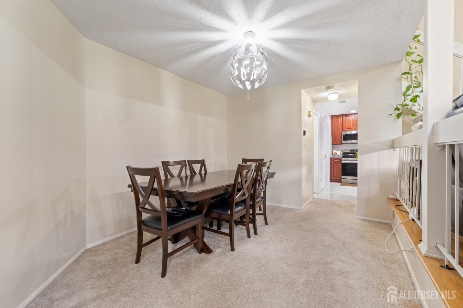 348 Westgate Drive Edison, NJ 08820 - Photo 17 of 43 a view of a dining room with furniture and chandelier