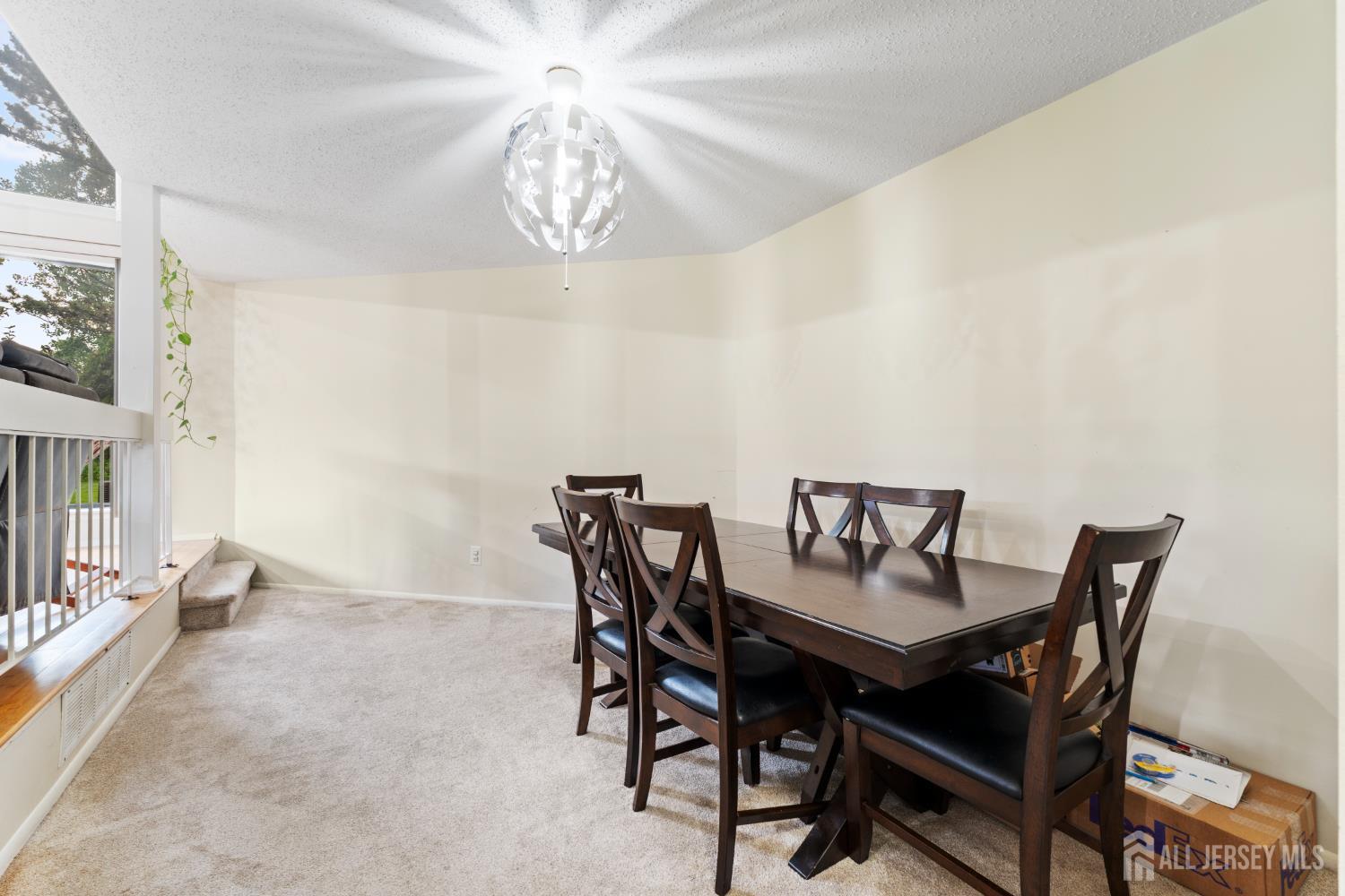 348 Westgate Drive Edison, NJ 08820 - Photo 18 of 43 a view of a dining room with furniture and chandelier