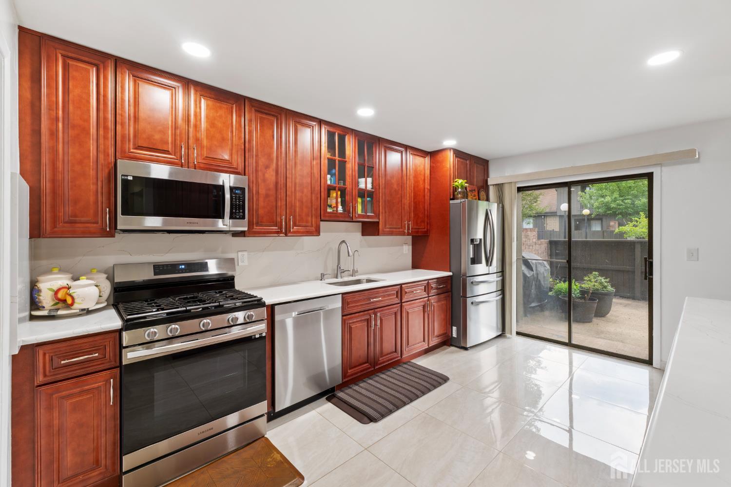 348 Westgate Drive Edison, NJ 08820 - Photo 20 of 43 a kitchen with stainless steel appliances granite countertop wooden cabinets a stove top oven a sink and dishwasher