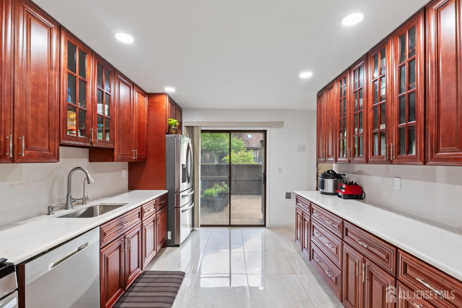 348 Westgate Drive Edison, NJ 08820 - Photo 21 of 43 a kitchen with stainless steel appliances a sink dishwasher and cabinets with wooden floor