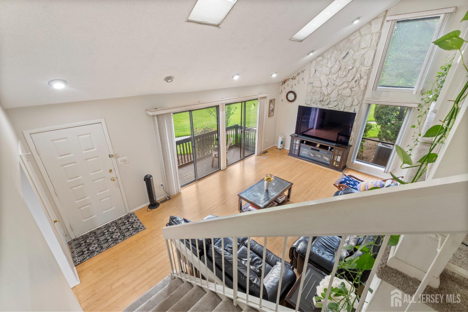 348 Westgate Drive Edison, NJ 08820 - Photo 27 of 43 a view of a livingroom with furniture a flat screen tv and front door