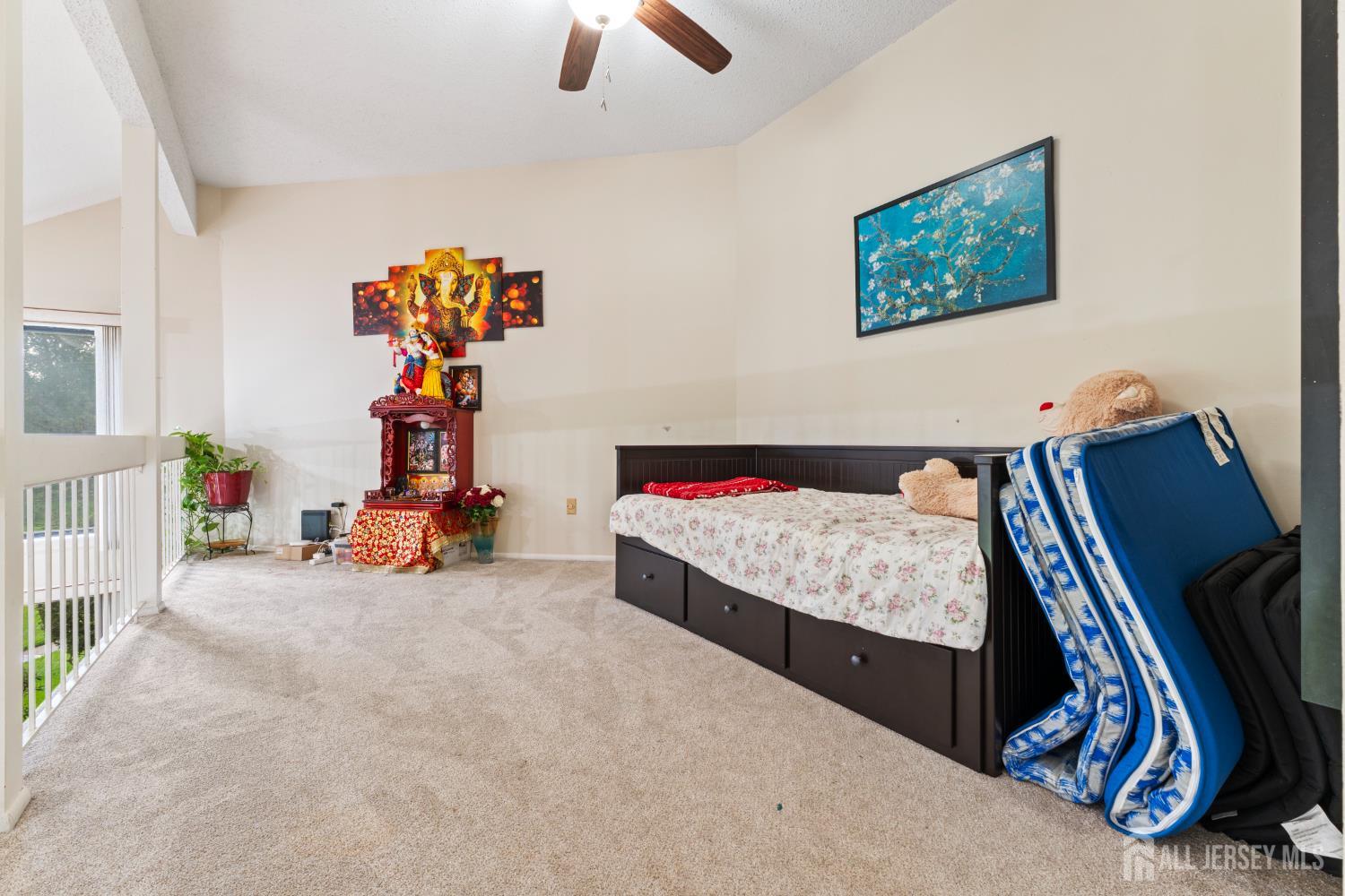 348 Westgate Drive Edison, NJ 08820 - Photo 28 of 43 a bedroom with furniture and a chandelier