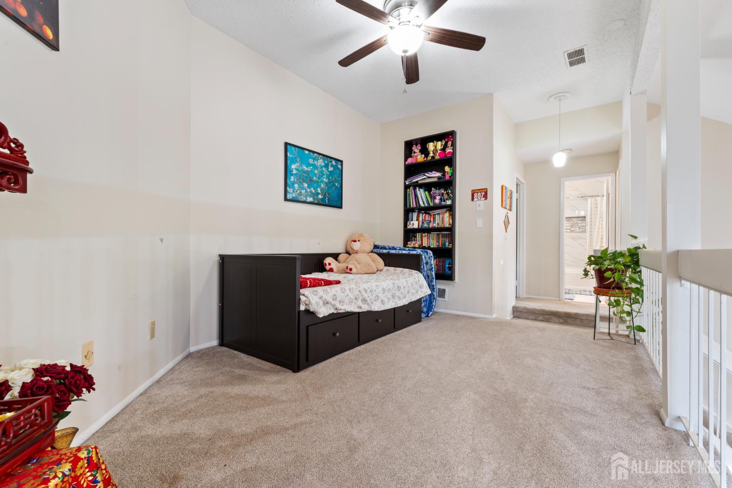 348 Westgate Drive Edison, NJ 08820 - Photo 29 of 43 a bedroom with a bed and a chandelier