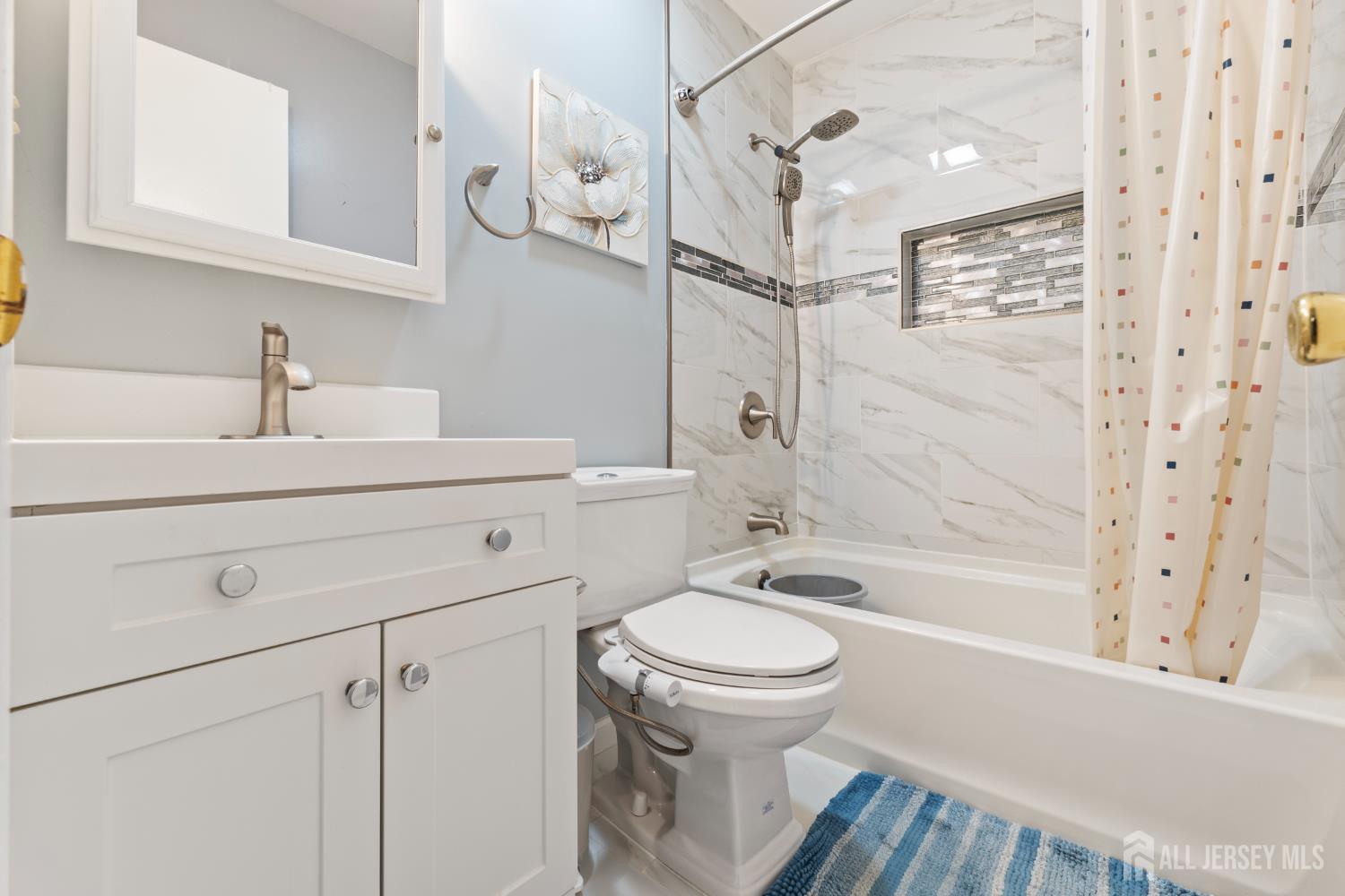 348 Westgate Drive Edison, NJ 08820 - Photo 33 of 43 a bathroom with a sink toilet a shower and bathtub