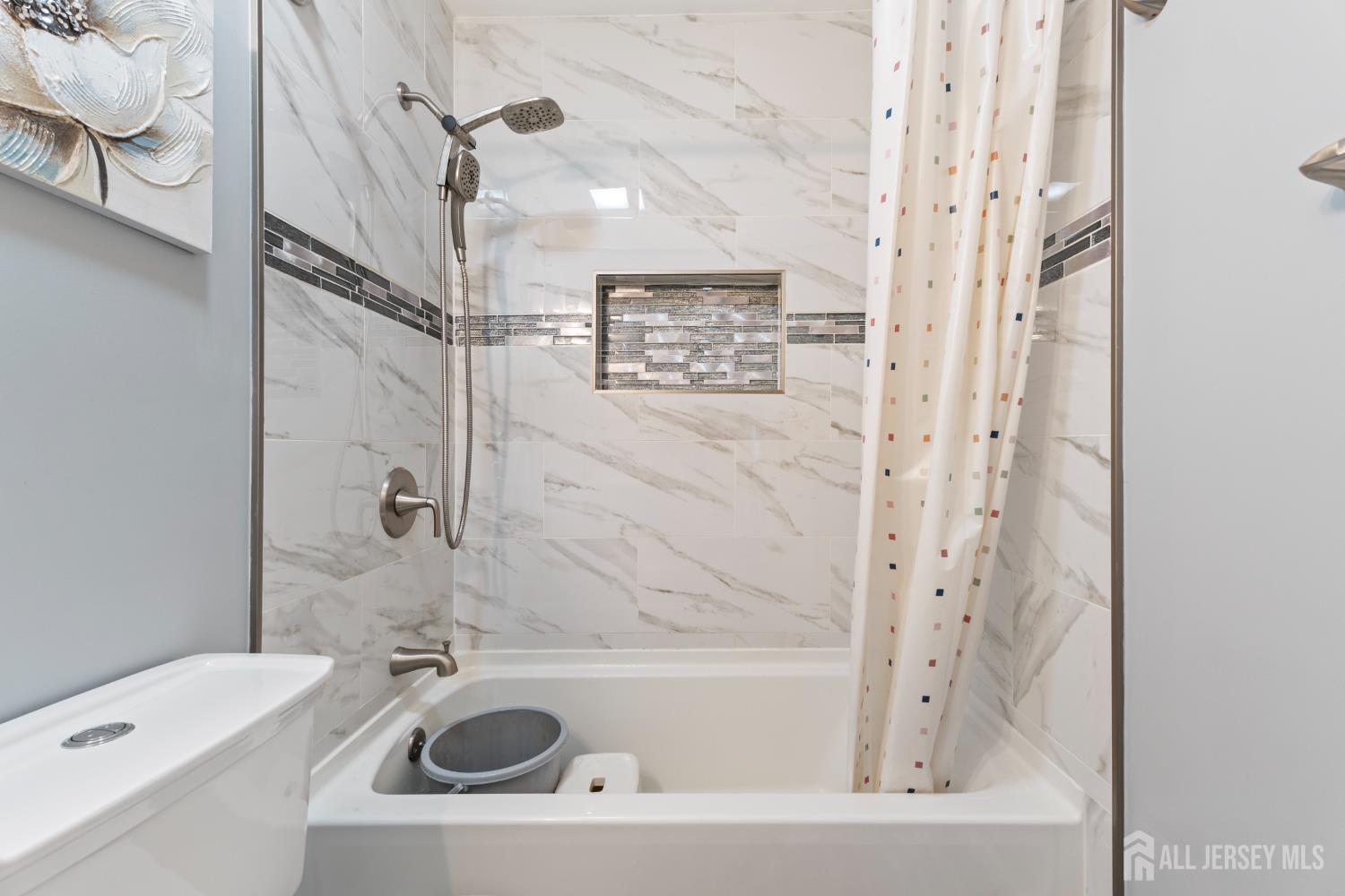 348 Westgate Drive Edison, NJ 08820 - Photo 34 of 43 a bathroom with a sink a mirror a shower and a bathtub