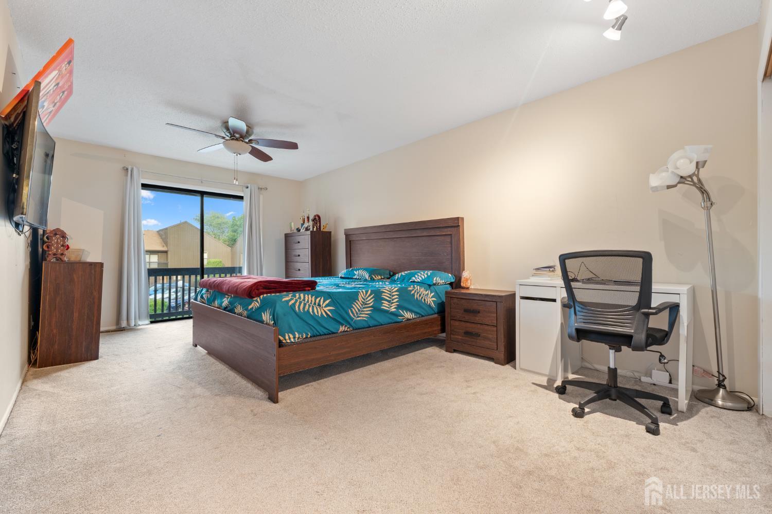 348 Westgate Drive Edison, NJ 08820 - Photo 35 of 43 a bedroom with a bed and a chandelier