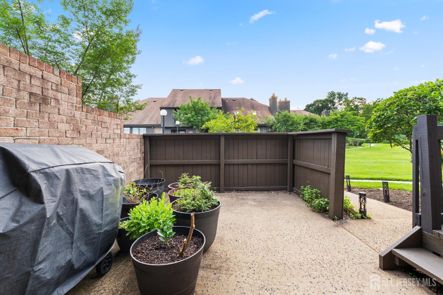 348 Westgate Drive Edison, NJ 08820 - Photo 7 of 43 a view of a garden with plants and a bench