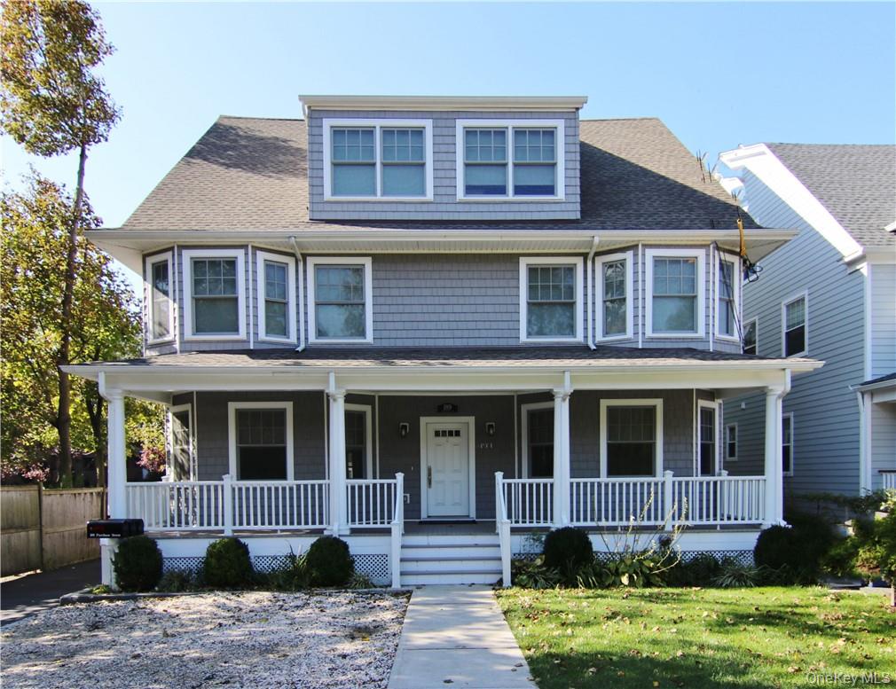 a front view of a house with a yard and porch
