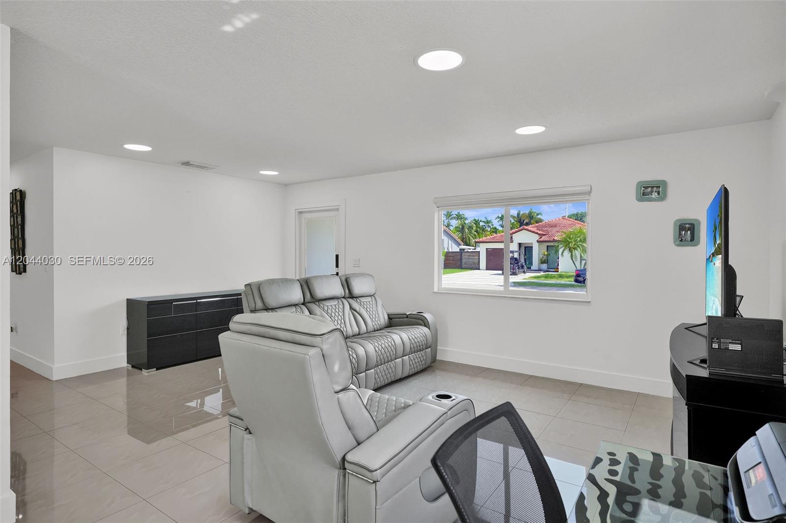 12551 Southwest 223rd Street Miami, FL 33170 - Photo 4 of 35 a living room with furniture and a flat screen tv
