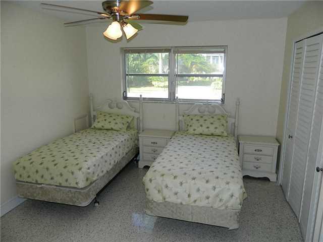 4639 Southeast Robertson Road Stuart, FL 34997 - Photo 16 of 21 a bedroom with a bed and a window