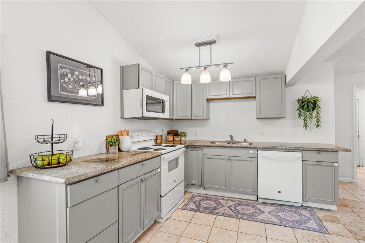 572 Pedersen Road Oakdale, CA 95361 - Photo 20 of 36 a kitchen with a sink a stove and cabinets