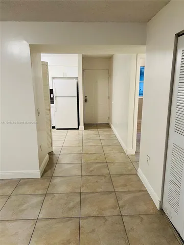 a kitchen with a stove a sink and a refrigerator