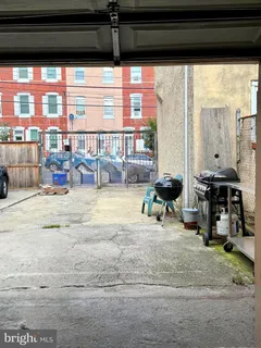 a view of a living room with furniture and a large window