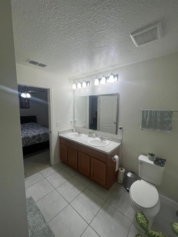 4668 Glencrest Loop St. Cloud, FL 34772 - Photo 4 of 5 a bathroom with a granite countertop sink mirror vanity and toilet