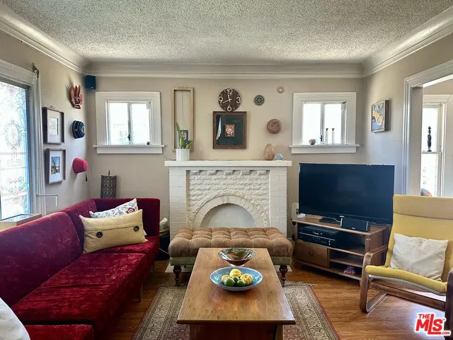 a living room with furniture a fireplace and a flat screen tv