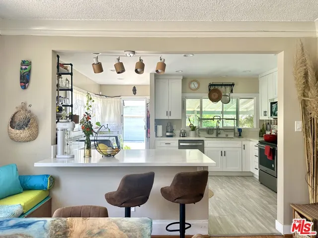 a kitchen with a dining table and chairs