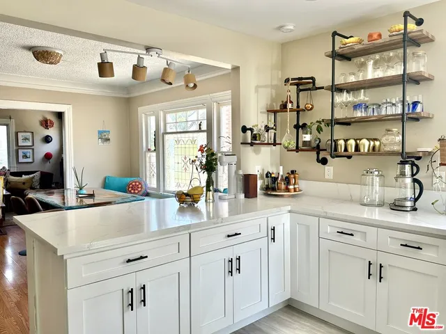 a kitchen with cabinets a sink and appliances