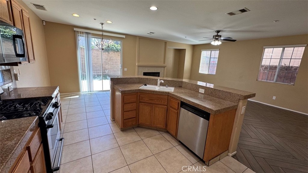 11332 Riverbury Court Riverside, CA 92505 - Photo 3 of 15 a kitchen with a sink stove and cabinets
